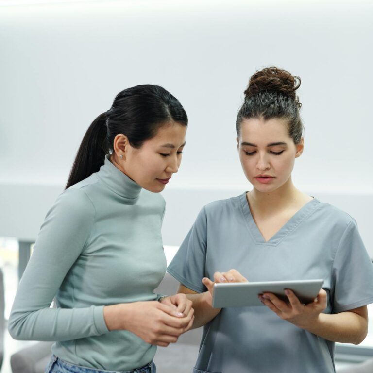 A Doctor and a Patient Looking at a Tablet