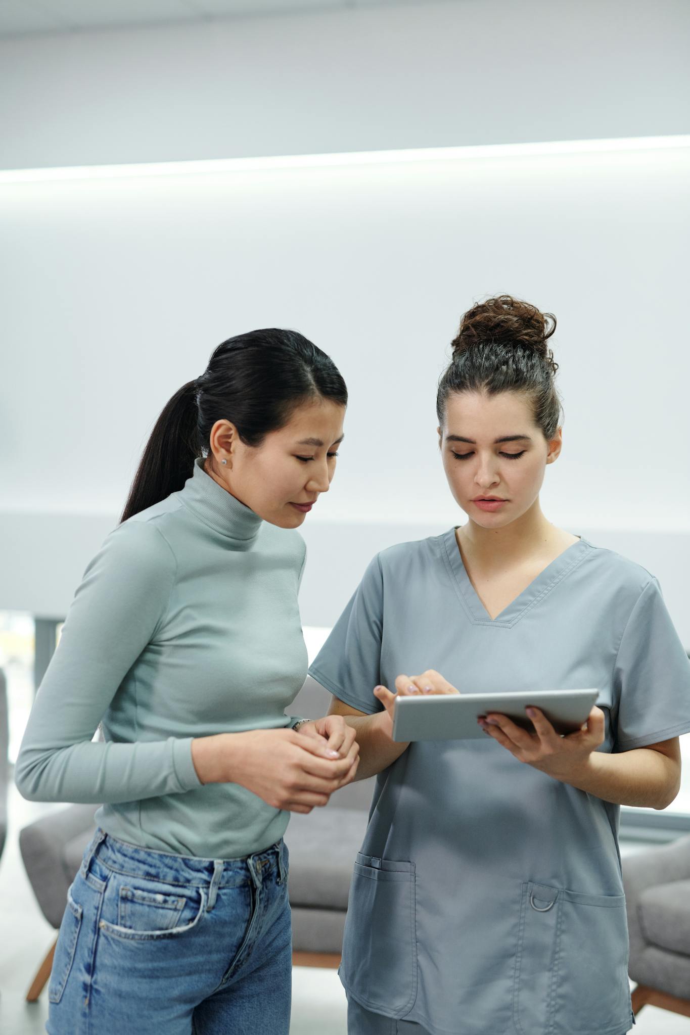 A Doctor and a Patient Looking at a Tablet