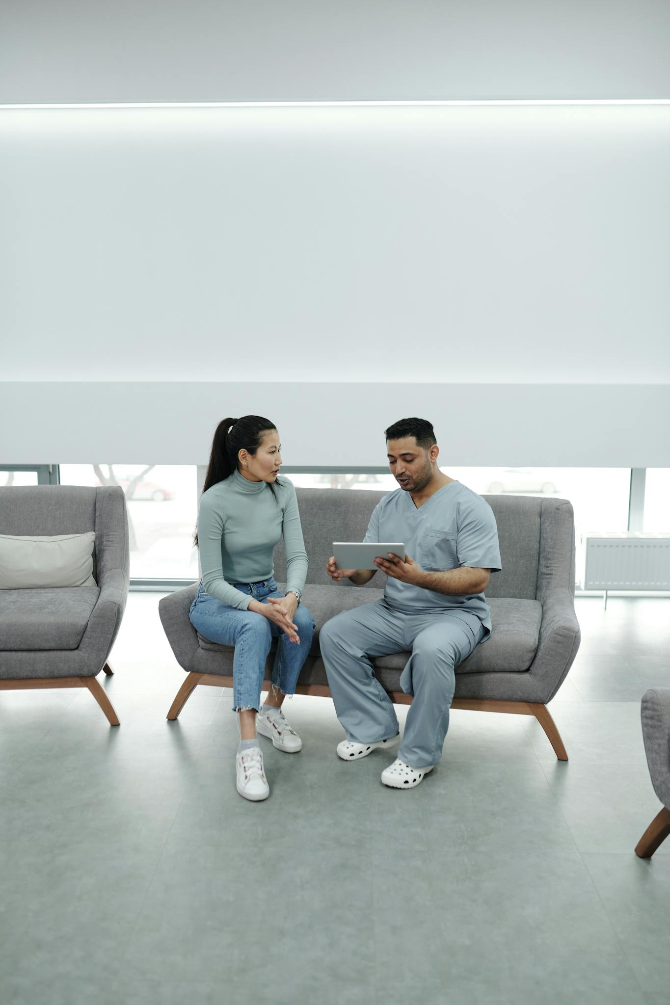 A Doctor Showing a Tablet to a Patient